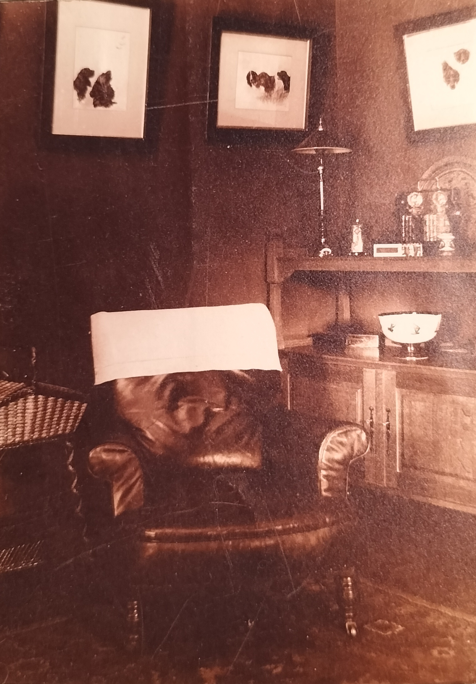 The reading chair in the corner of the lounge. Note the sewing basket as well as the framed dog pictures on the wall.