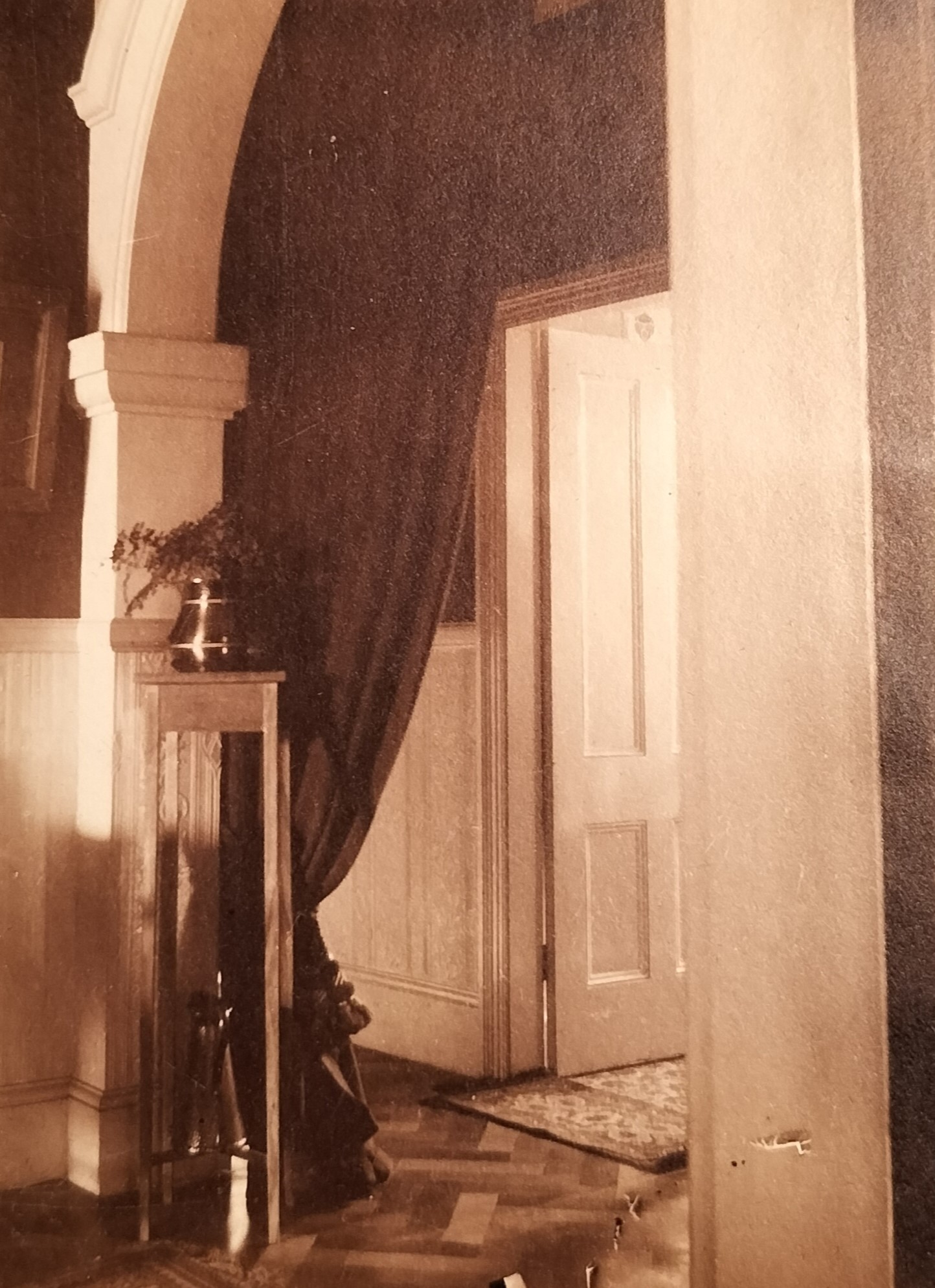 Still in the entrance hall leading into the main house. Note the parquet wooden flooring. The unusual positioning of the curtain in the arch was probably intended to reduce any draft during colder months.