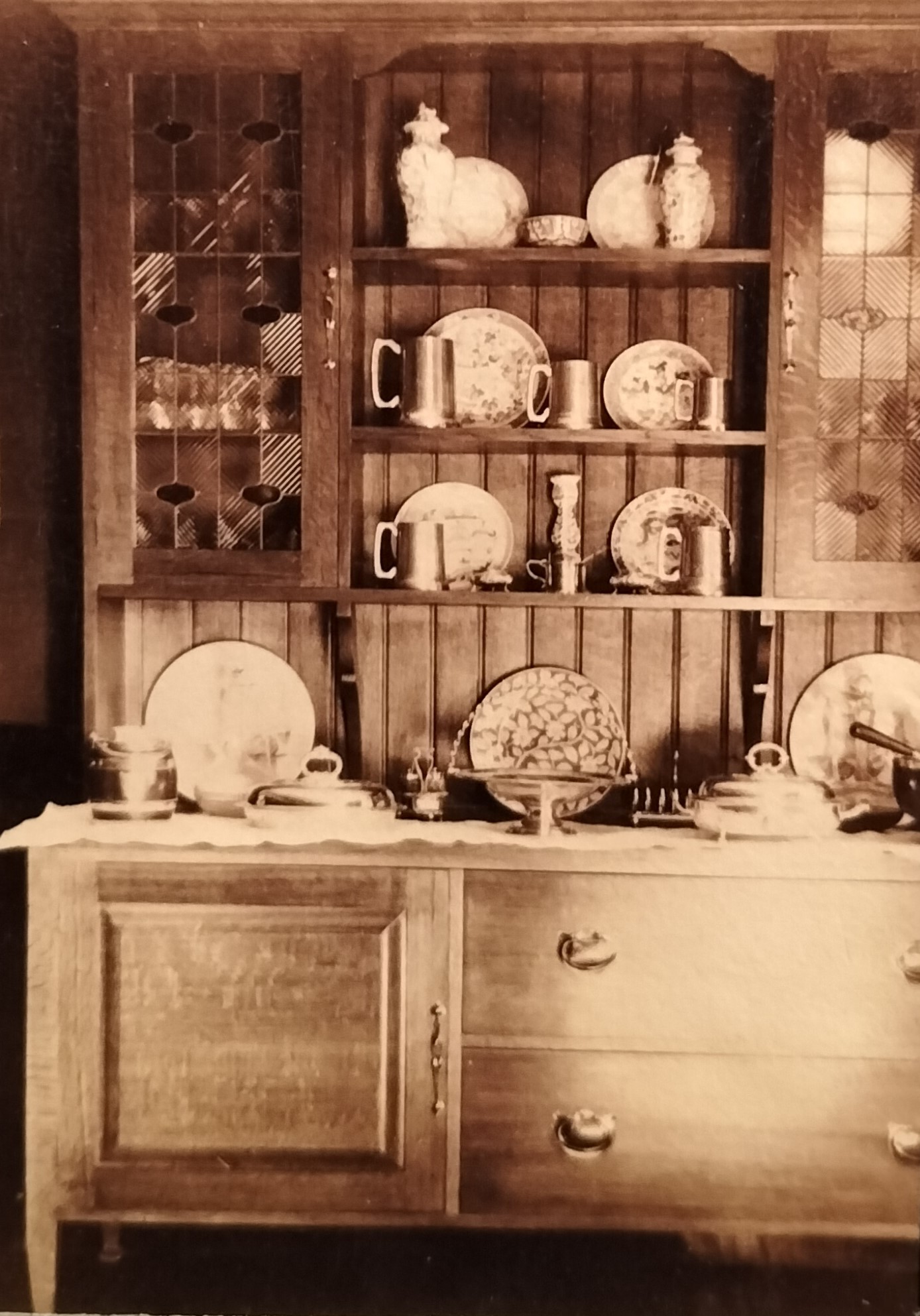 The sideboard in the dining room with stained glass doors