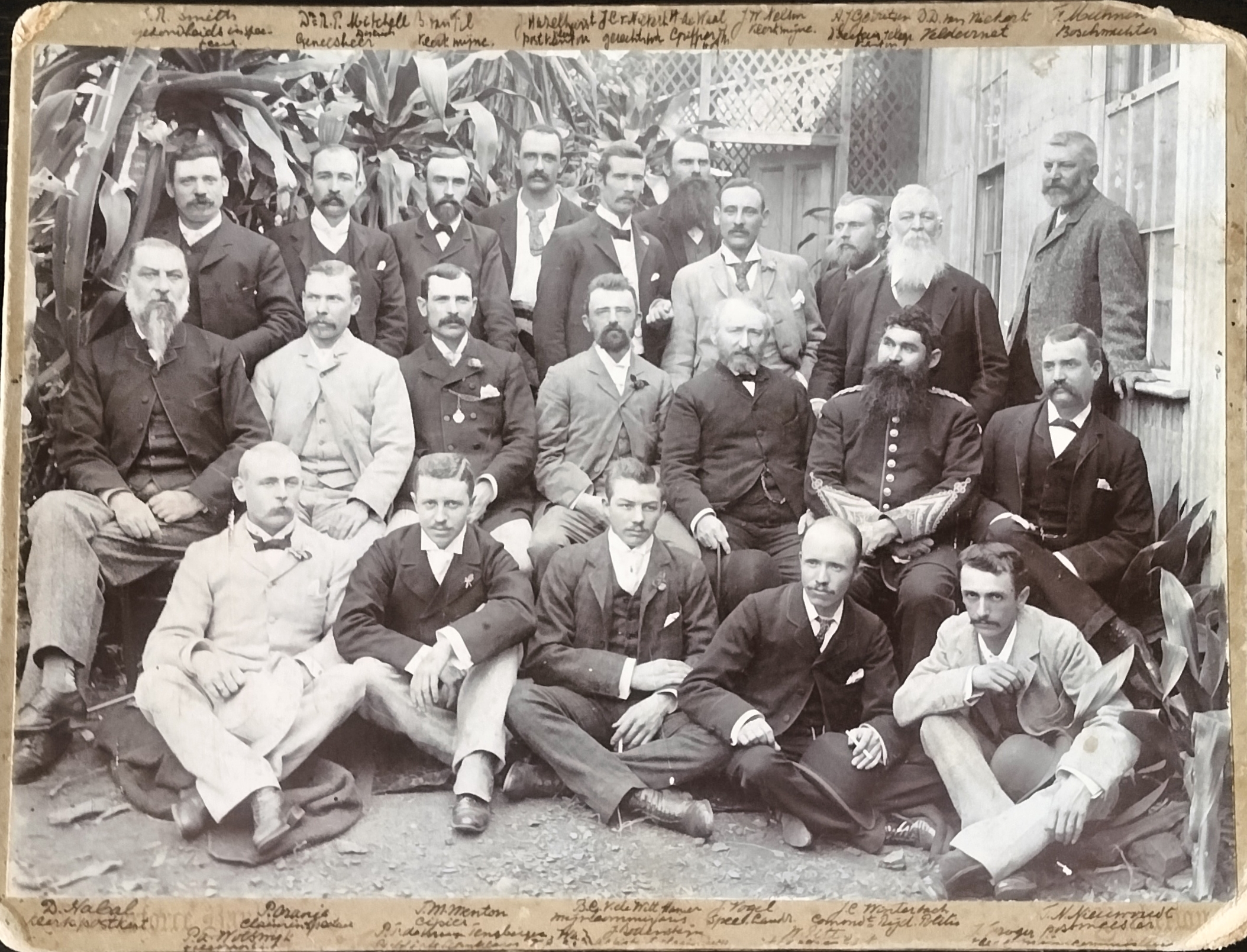 Original photograph with names of twenty-two ZAR employees based in Barberton captured in writing on the top and the bottom of the photograph. The photographer of this 1893 photograph is Wilberforce Bayly