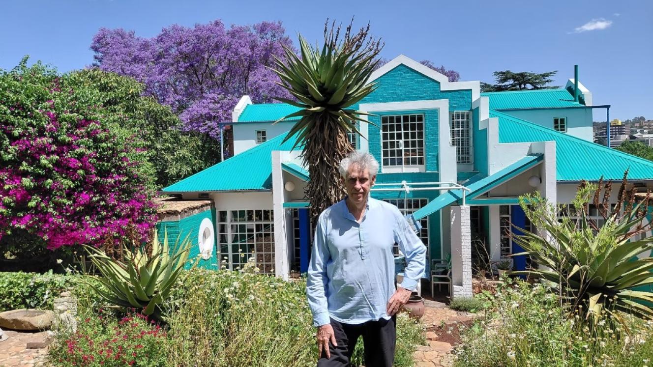 Peter Rich in his terraced garden in front of his home