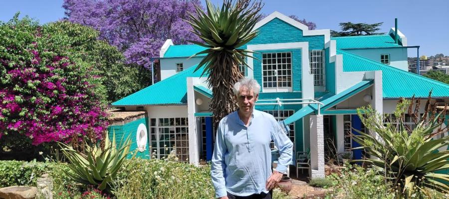 Peter Rich in his terraced garden in front of his home