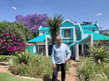 Peter Rich in his terraced garden in front of his home