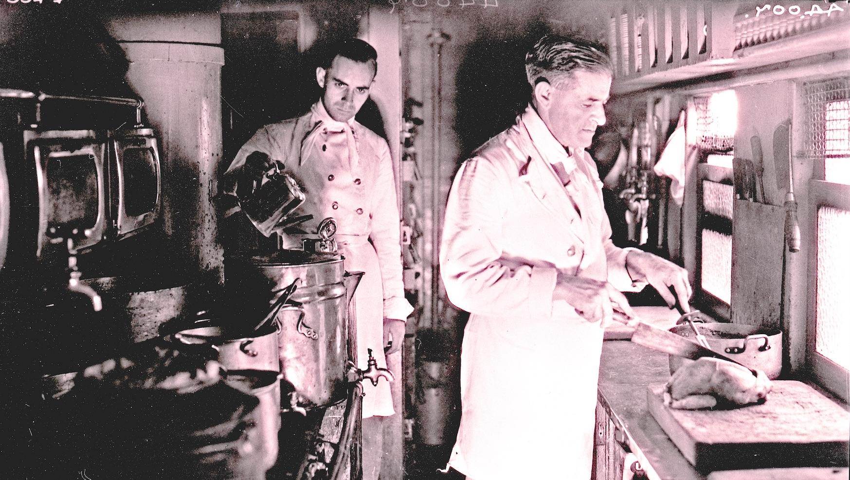 Chef working in an AA23 kitchen car - Transnet Heritage Library