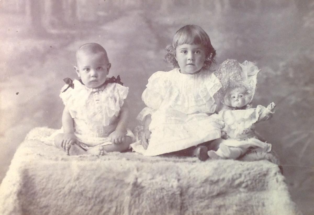 Cabinet format photograph circa 1904 by East London based photographersJakins and Co showing unknown young girl with her doll and younger sibling via Carol Hardijzer