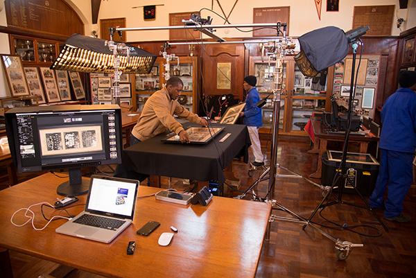 The team loading framed prints onto the table beneath our digitization rig in the Kingswood College Museum