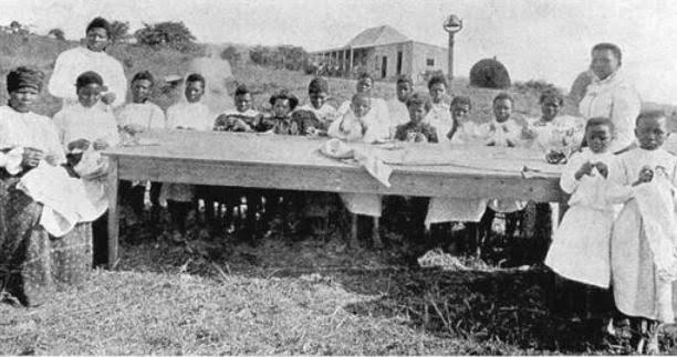 Mrs Dube Sewing Students at Ohlange via Daluxolo Moloantoa