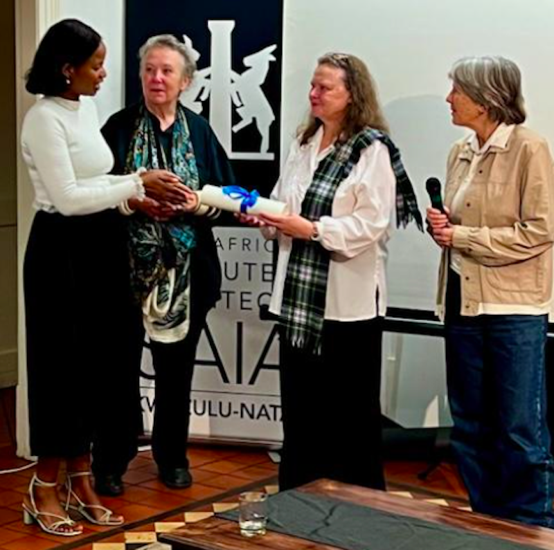 Ros Devereux, 2nd right, receiving her scroll from Sandisiwe Matole of Amafa.